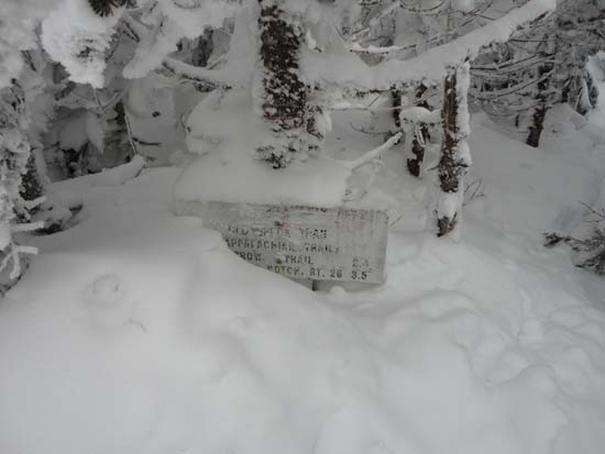 A hiking sign just barely visible above deep snowpack on Old Speck Mountain (February 2011)