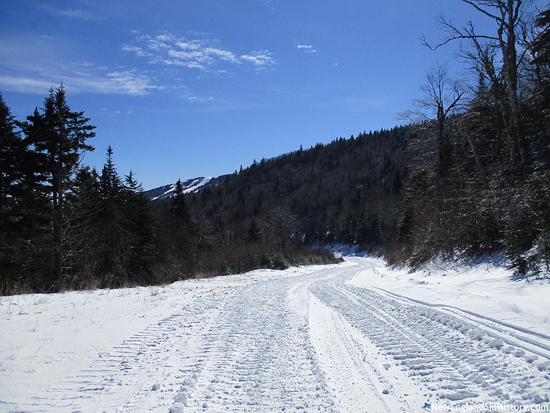 Looking down the connector trail with Killington's Skye Peak in the distance (2016)